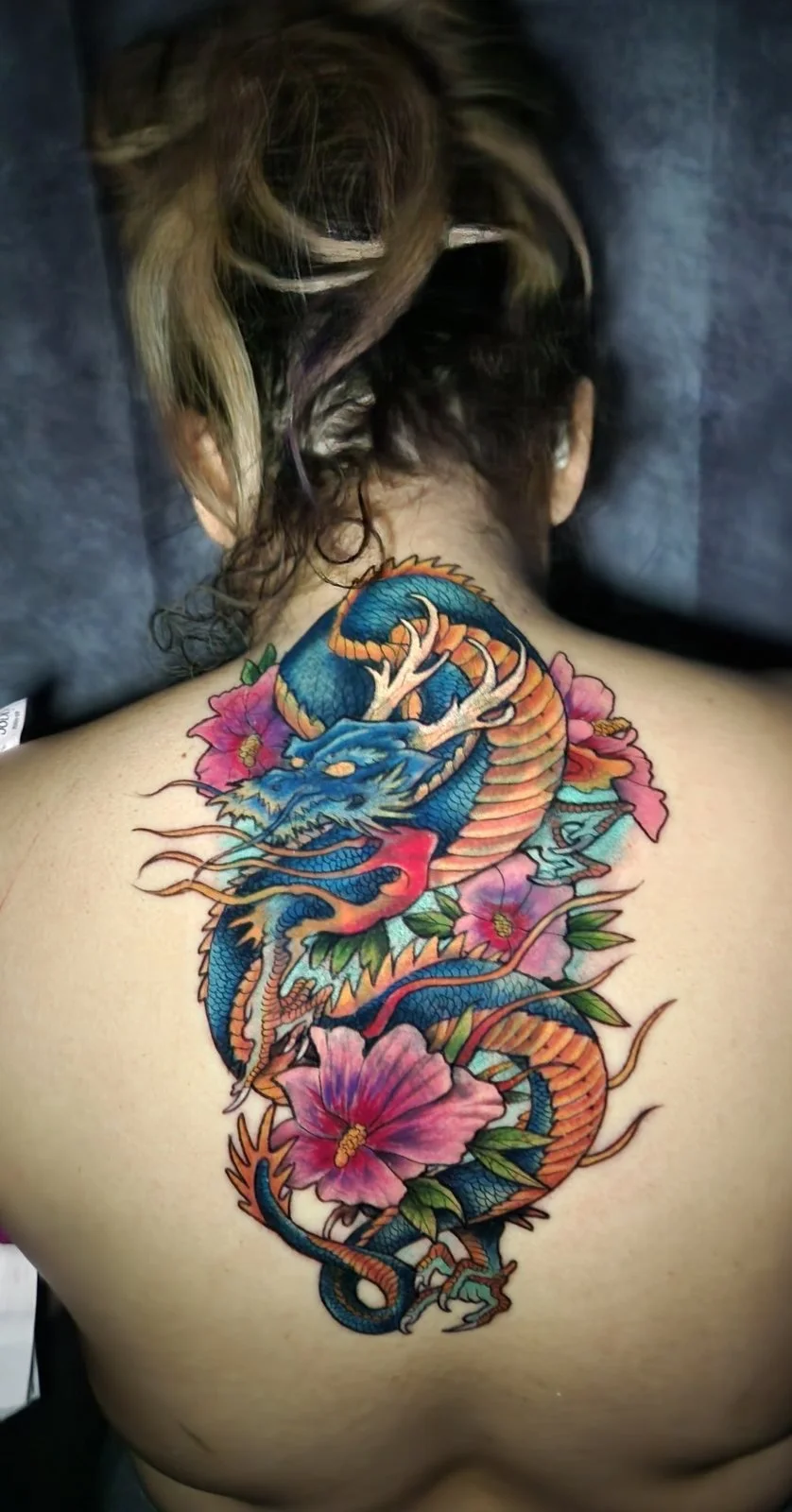 Color Japanese dragon with hibiscus flowers covering old upper-back tattoo