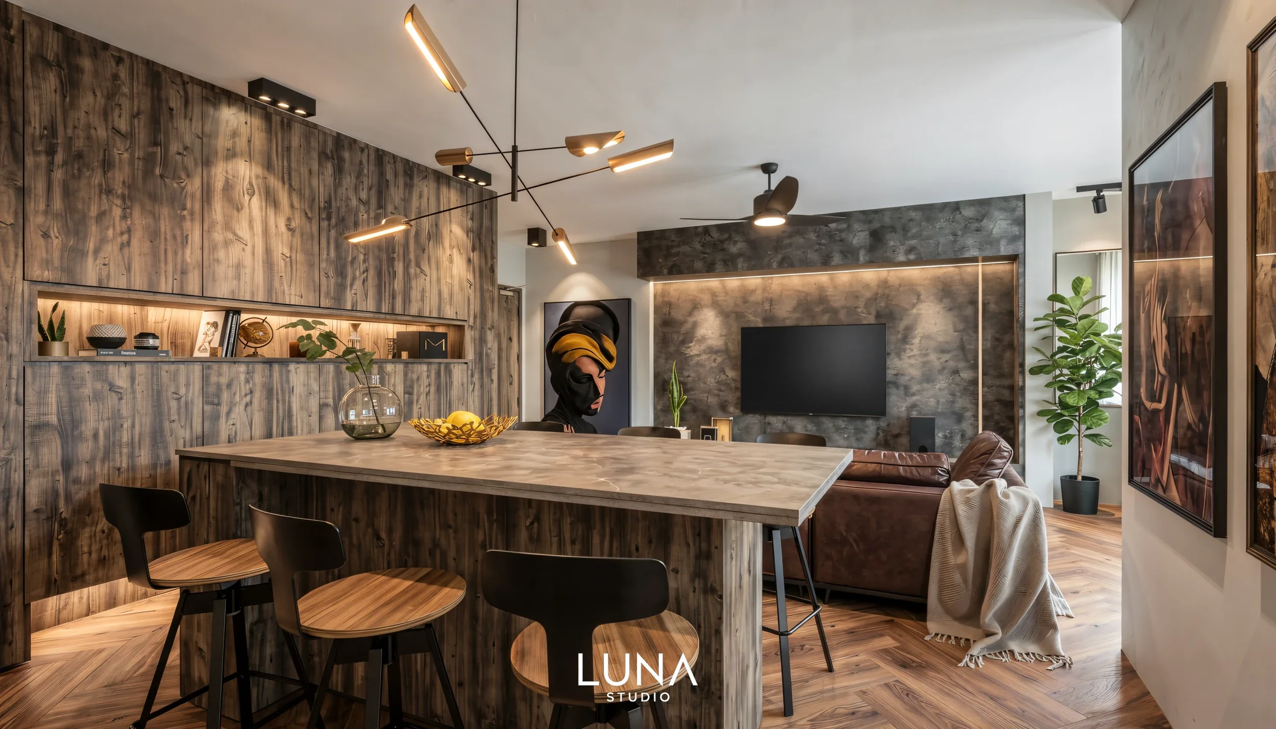 Open kitchen island with statement lighting, looking across the living area to the TV feature wall.