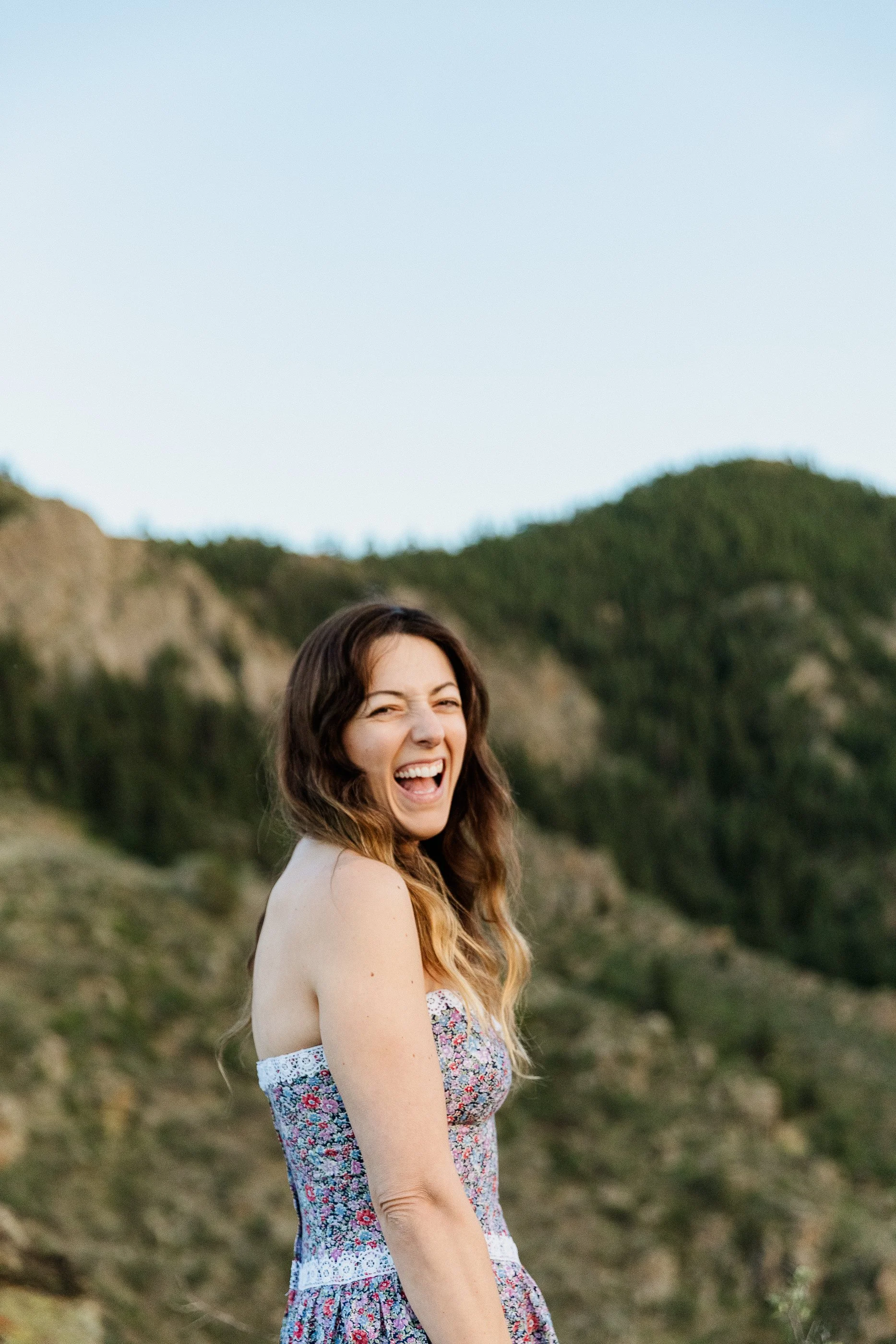 Colorado elopement photographer Kimberly Crist outdoors with her camera, photographing a couple eloping