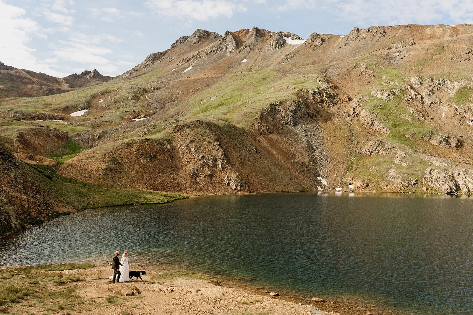Couple and their dog at an alpine lake near Silverton, Colorado