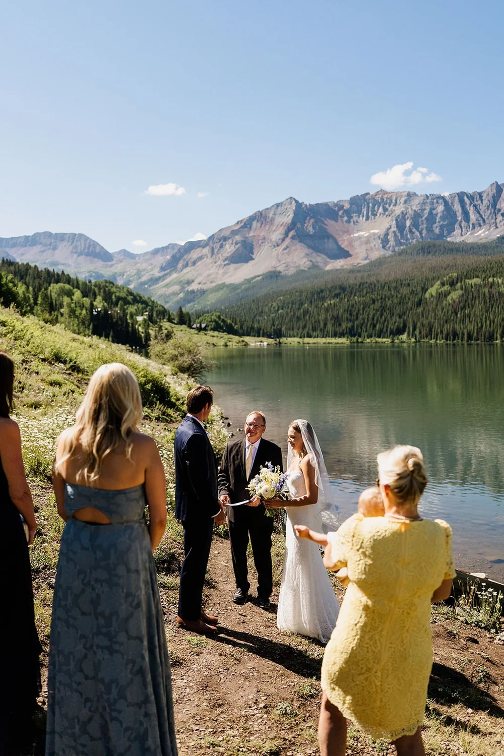 Small group ceremony at a mountain lake