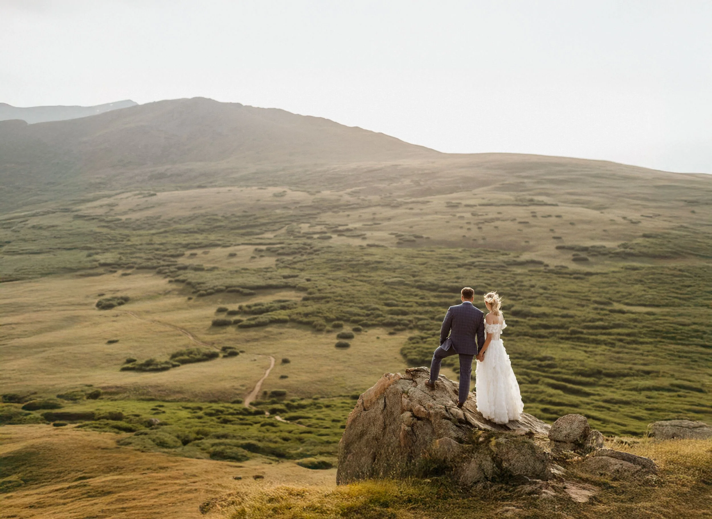Couple sharing private vows in low fog on Guanella Pass during their summer elopement near Georgetown, Colorado