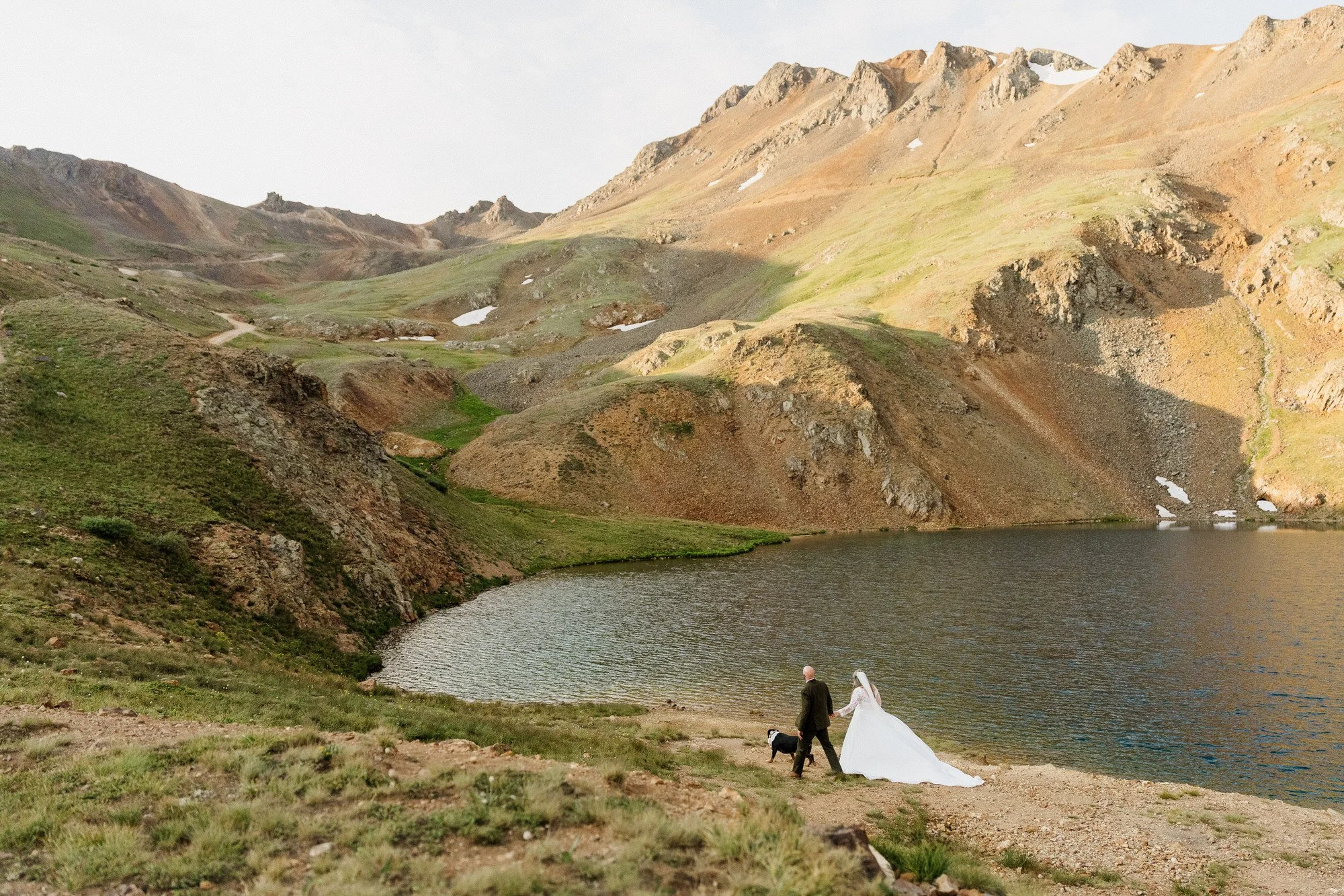 Couple standing together in a mountain meadow during their Colorado elopement