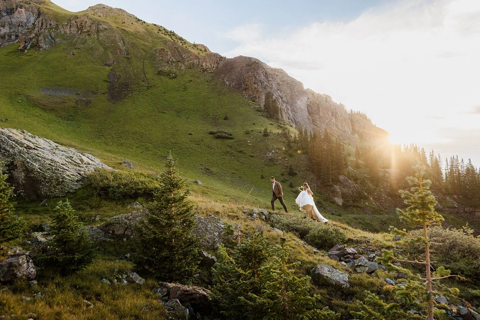 A couple walking back to the car in late light, second photographer's frame from further down the trail