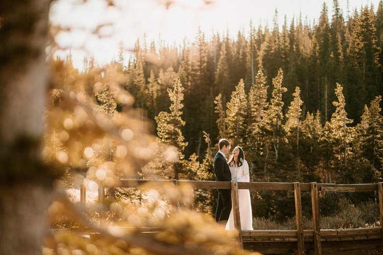Walking the shoreline at Long Lake after a Colorado elopement ceremony