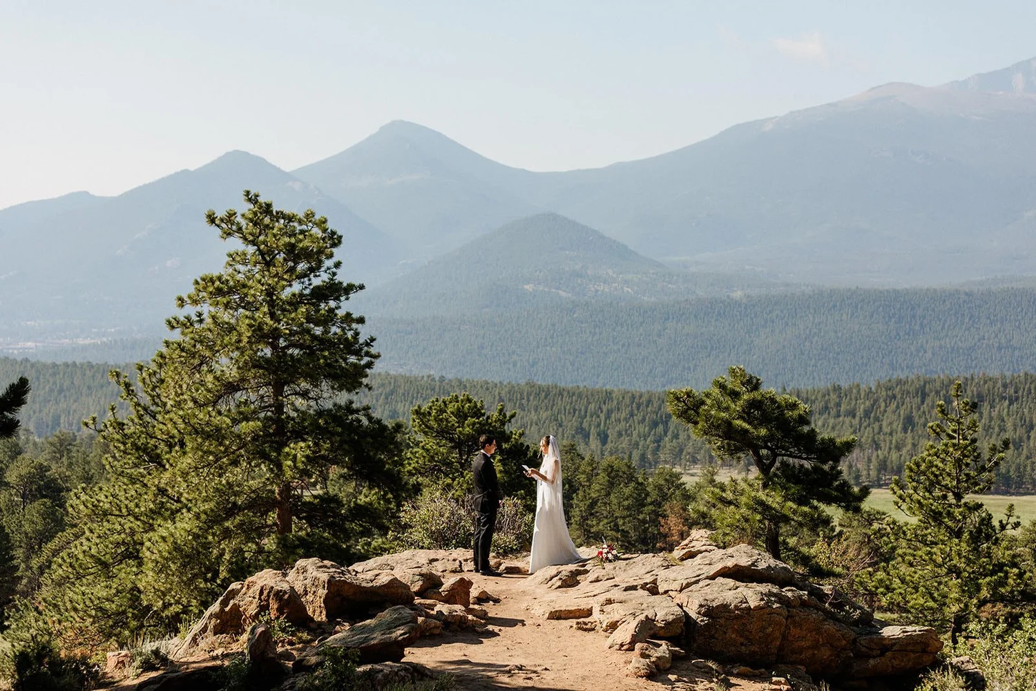 A couple reads vows at 3M Curve in Rocky Mountain National Park, an elopement ceremony spot a short walk from the car