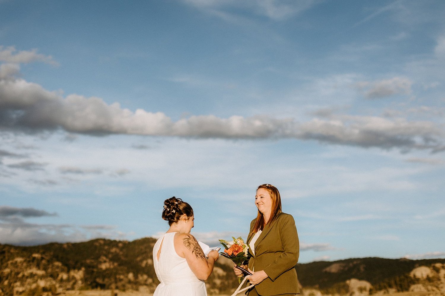 Reading handwritten vows from paper at a Colorado elopement