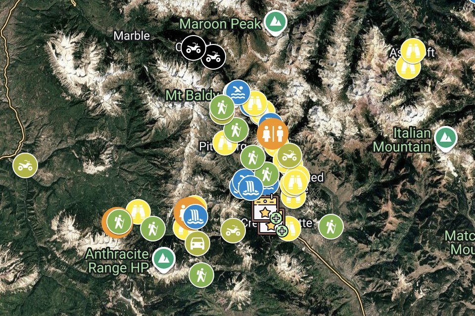 Satellite map of the mountains around Crested Butte, Colorado, covered in pins marking elopement locations