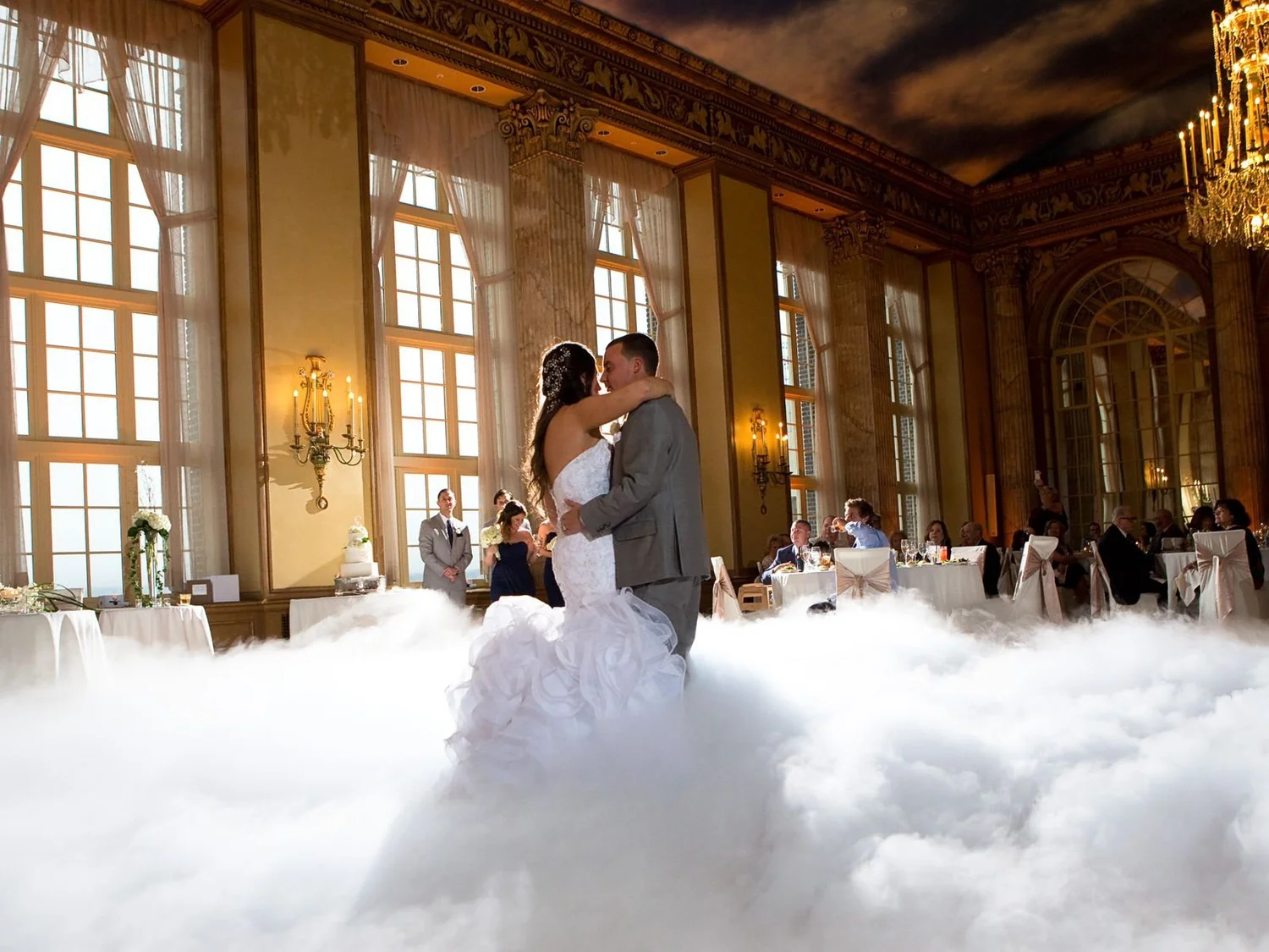 A first dance on a cloud of fog in a ballroom