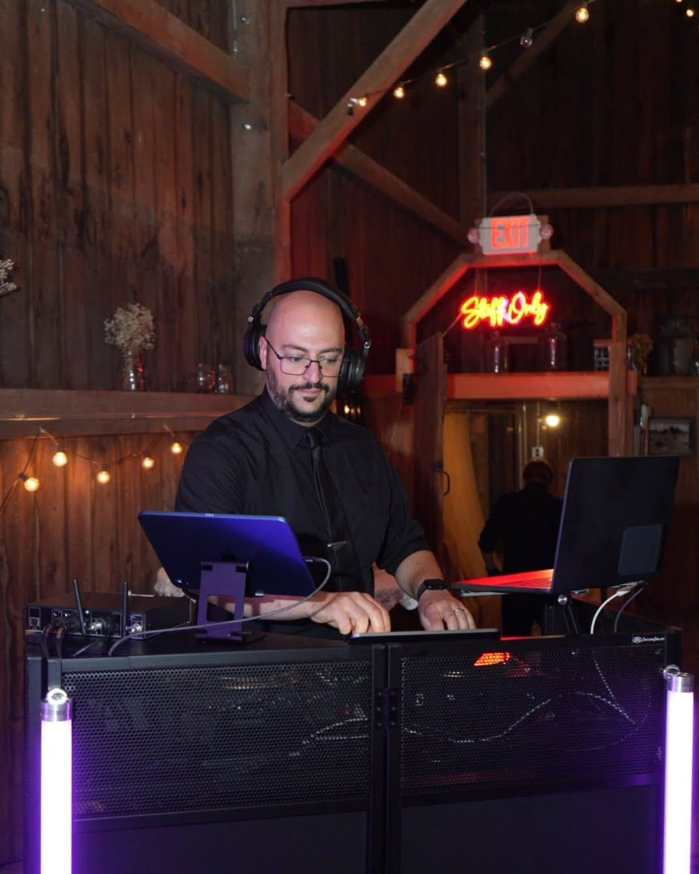 Jonathan DJing a wedding in a barn