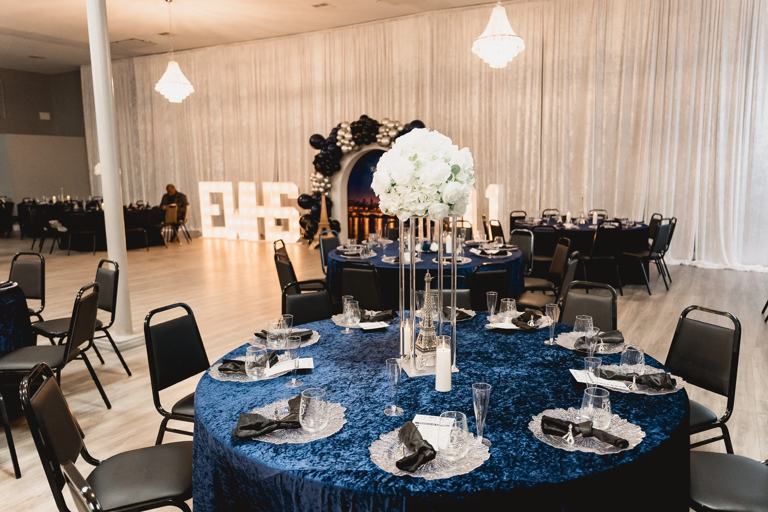 Blue table linens and white floral centerpieces set the scene for the reunion.