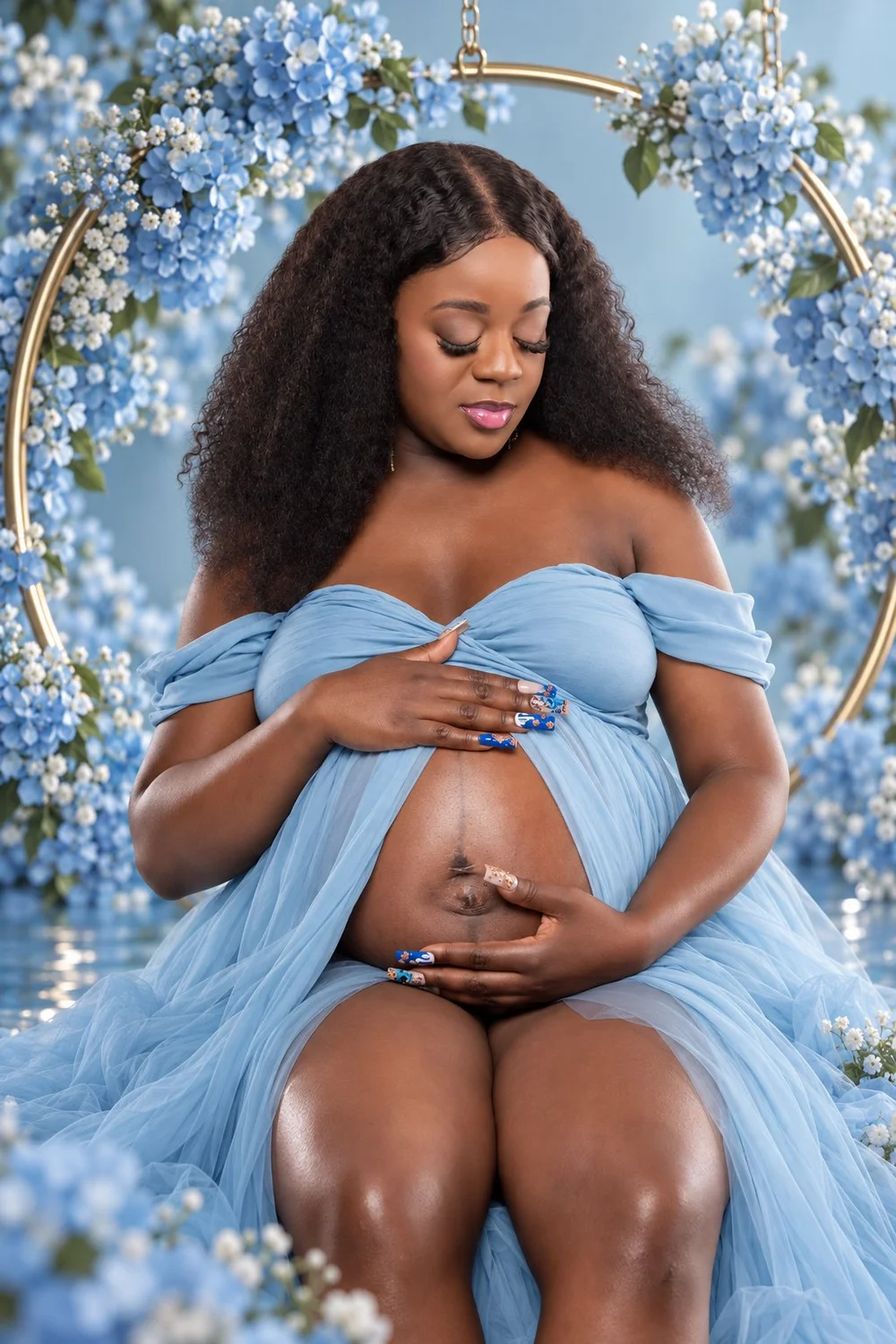 Close-up maternity portrait of Capria cradling her belly with blue floral surroundings