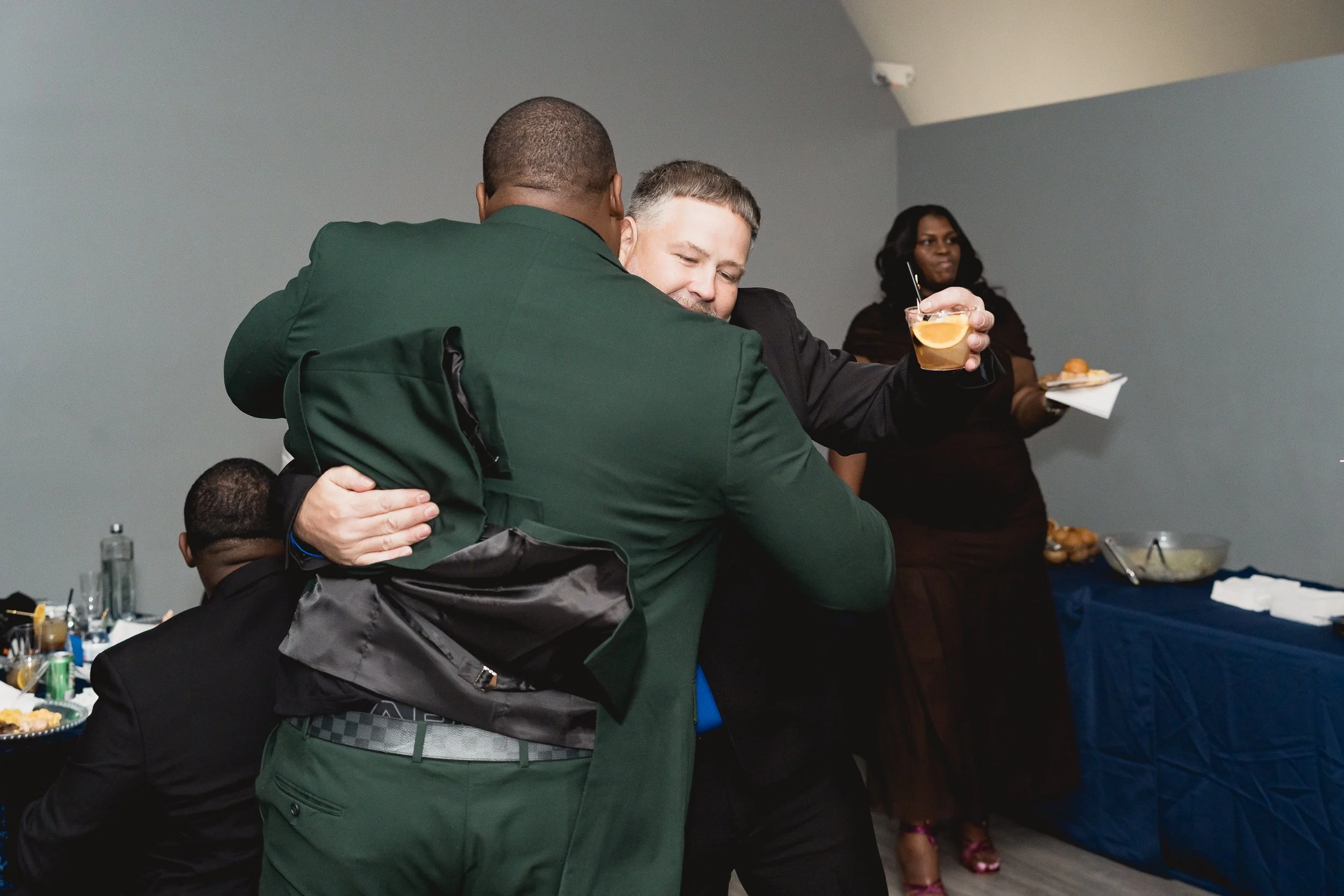 Two guests share a warm embrace.