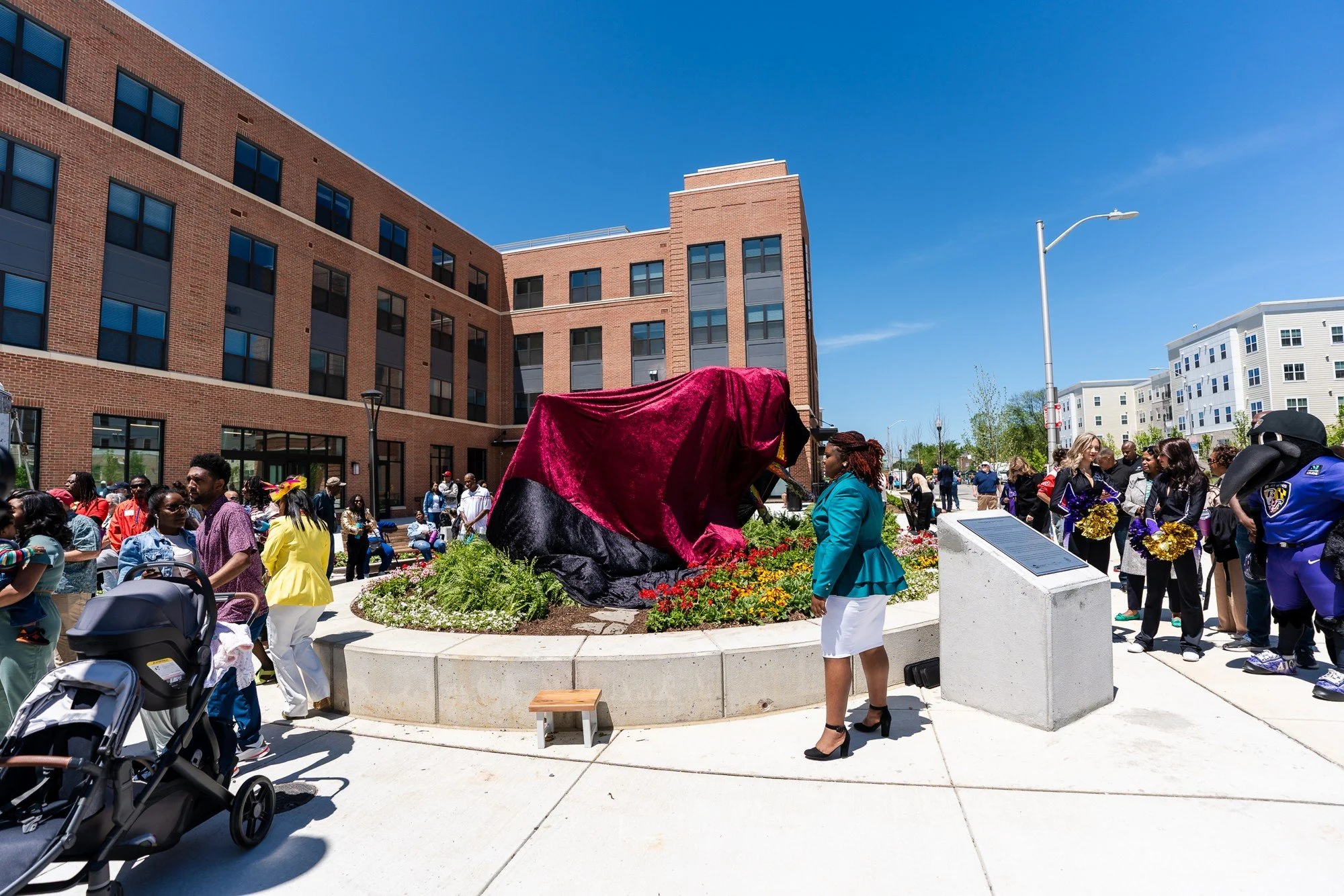 Neighbors gather ahead of the unveiling.