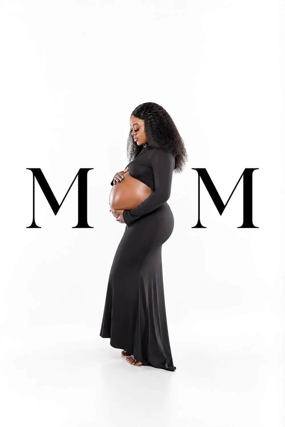 Capria in a black maternity outfit between two large M letters on a white backdrop