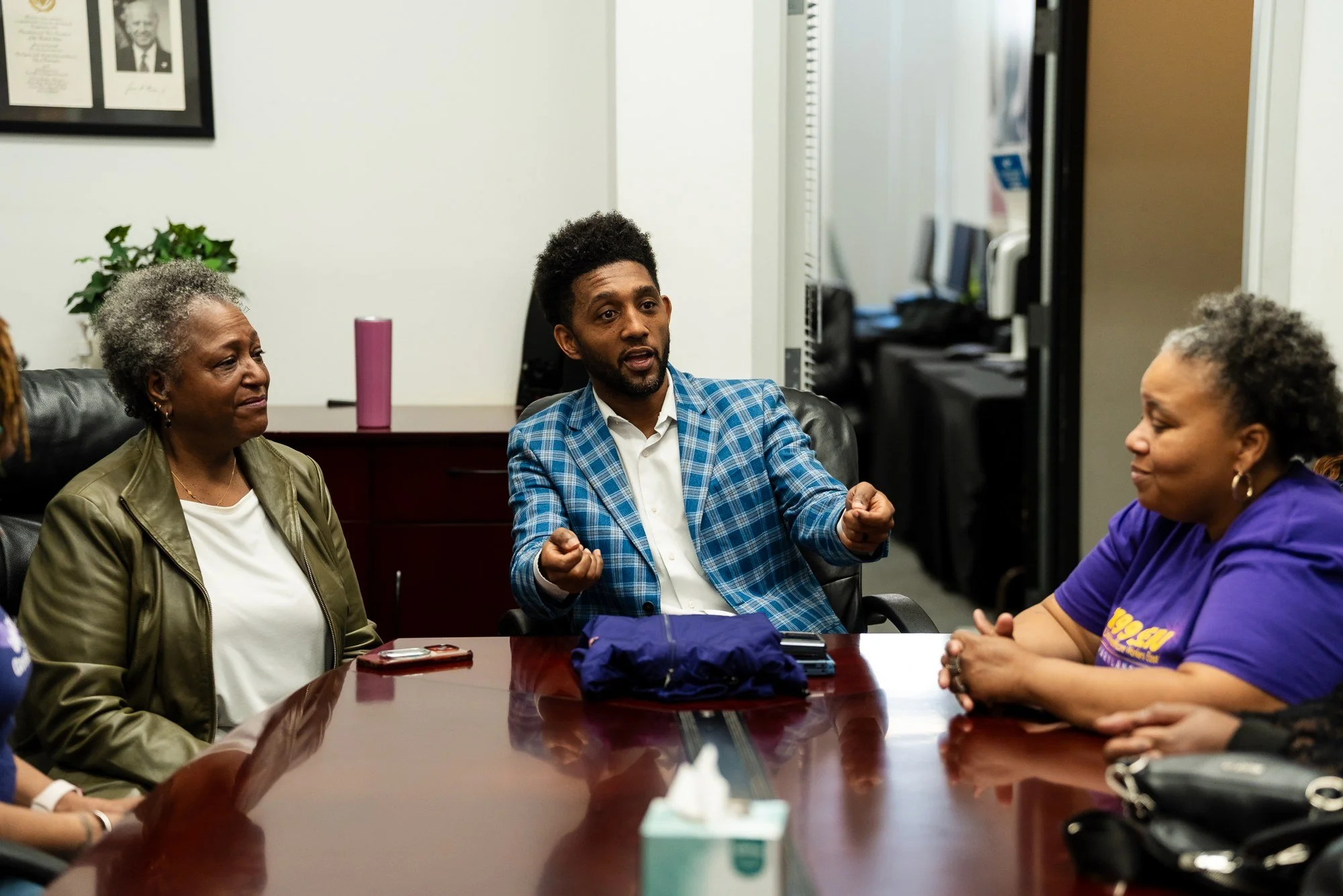 Baltimore City Mayor Brandon Scott in conversation with attendees at a community roundtable