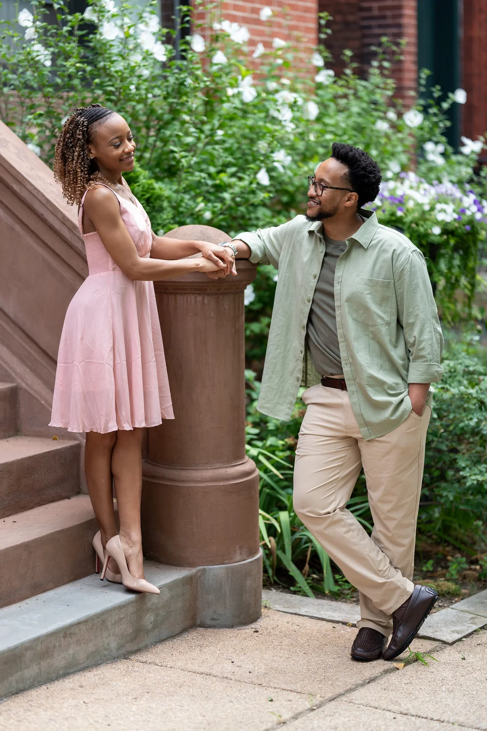 Brook and Morgan holding hands beside Baltimore brownstone steps