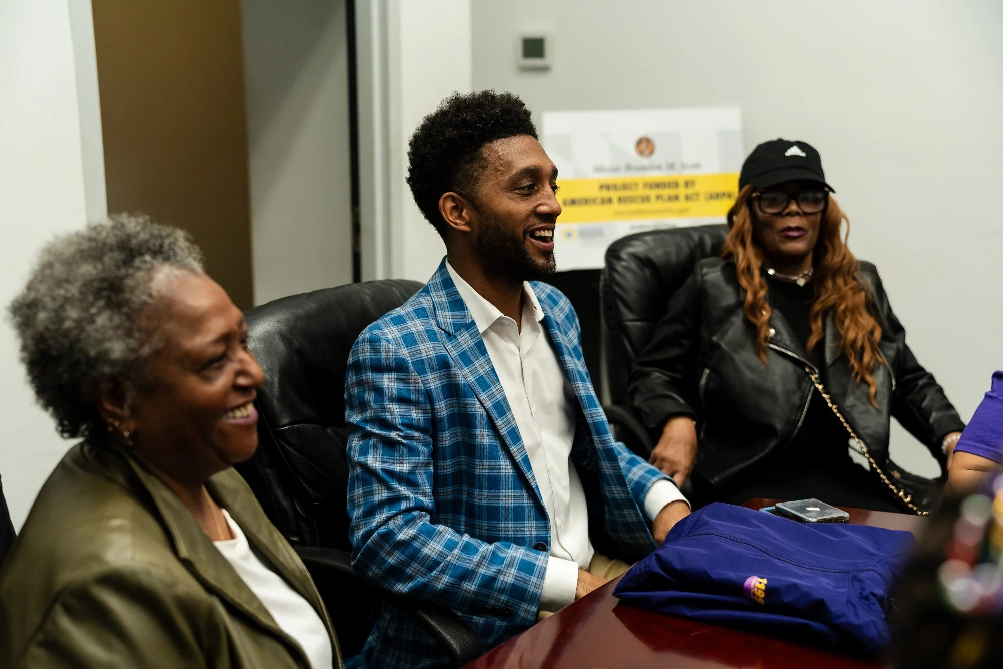 Baltimore City Mayor Brandon Scott sharing a lighthearted moment with attendees at a community roundtable