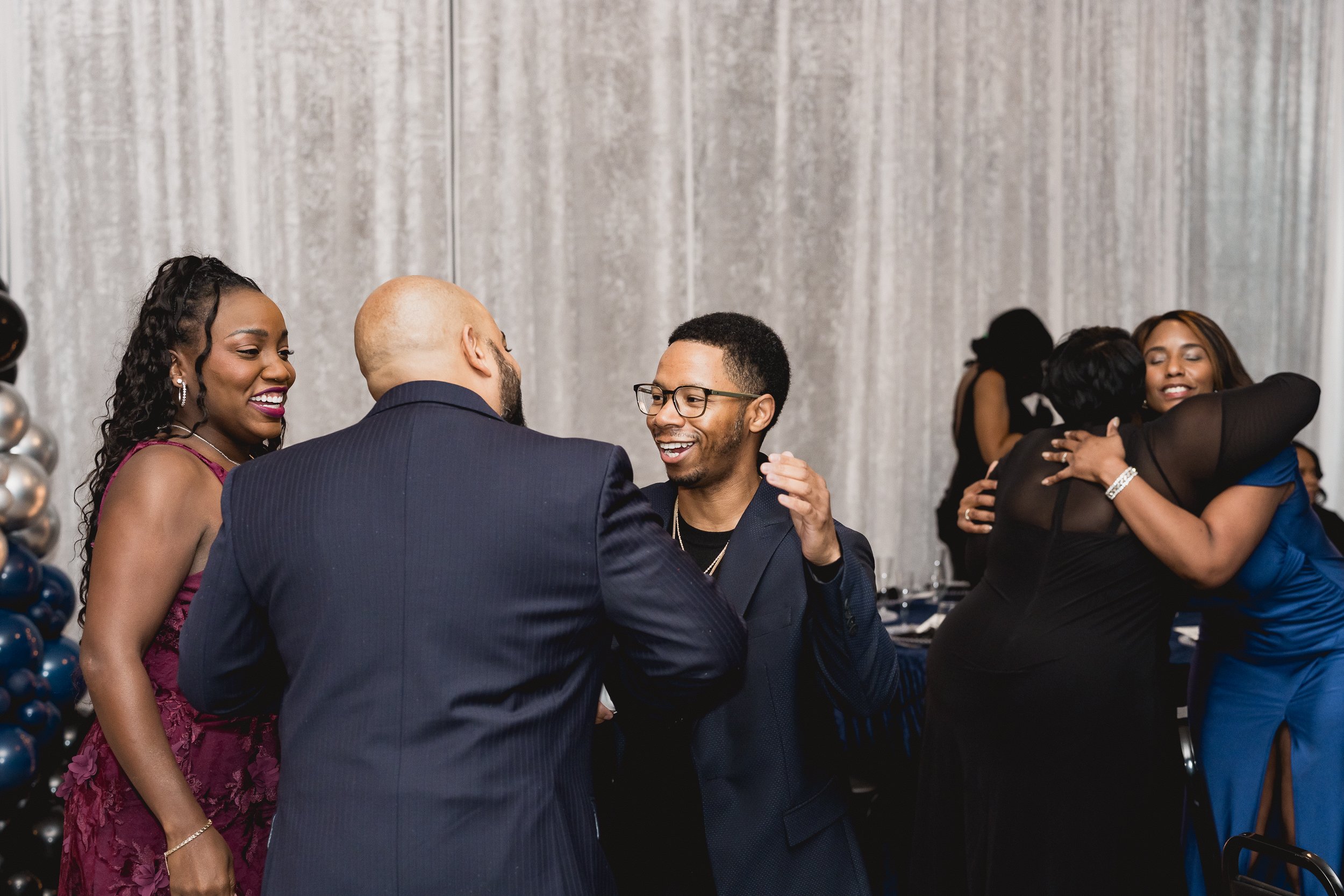 Guests greet one another and share conversation.