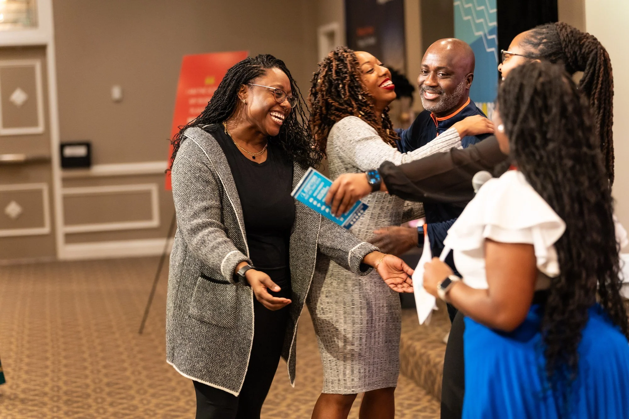Attendees sharing a joyful greeting at Baltimore Biz-Con
