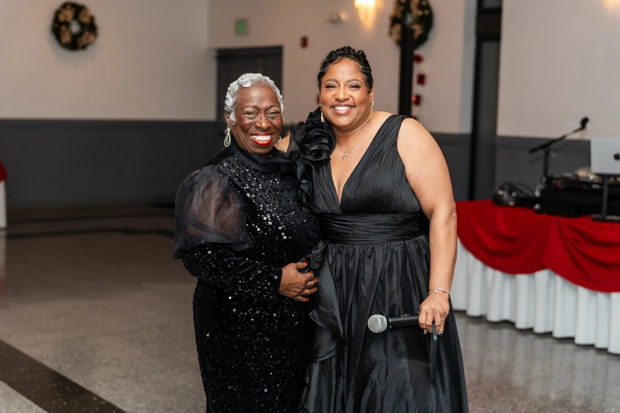 Two guests smiling together at the Kidz Stuff holiday party