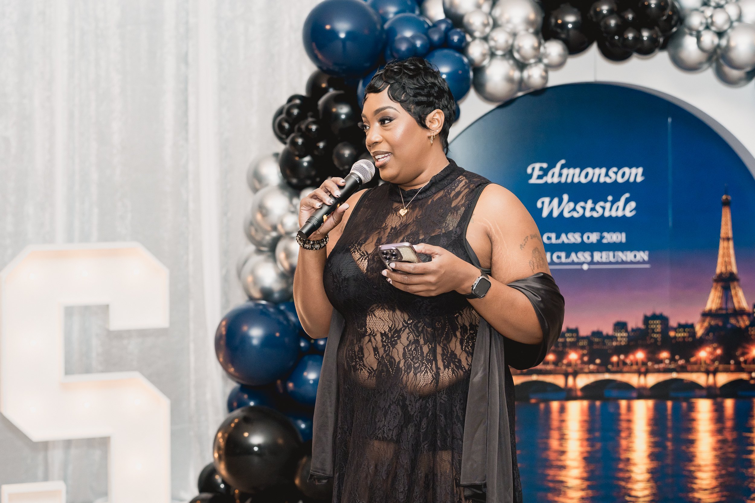 A speaker addresses the reunion with a microphone.
