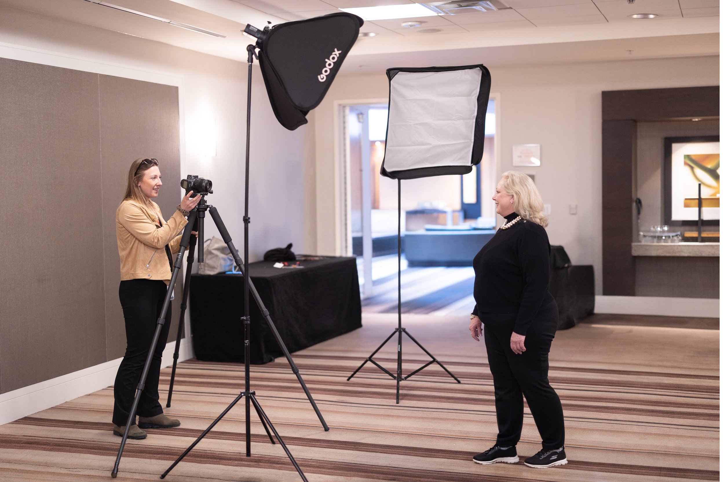 Mark Campbell Productions photographer working a busy corporate headshot station with attendees waiting their turn