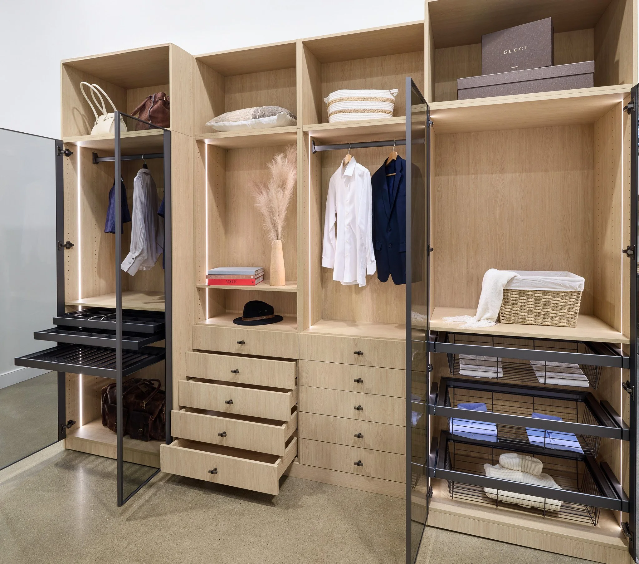 Natural Oak closet with open drawers, pull-out trays and glass-front units