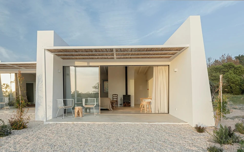Farmhouse Suite 1 terrace with open doors into the bedroom at Amaria