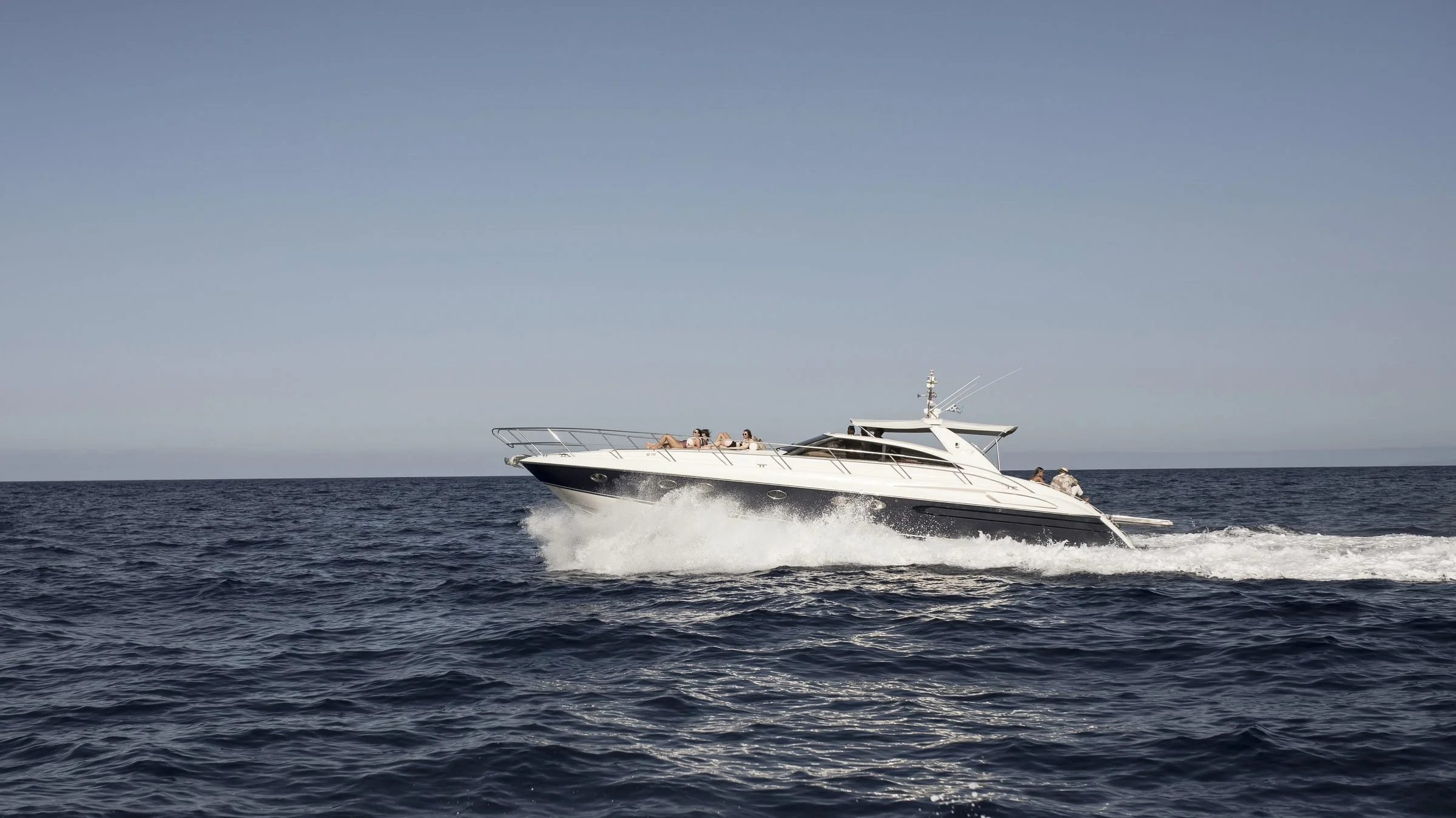 A private yacht underway on open turquoise water off Zakynthos, Greece, on the yacht day of the Casa Retreats Greece 2027 yoga retreat