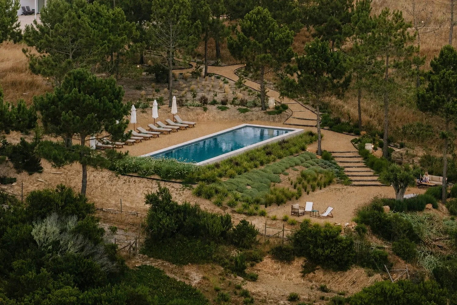 Amaria&rsquo;s rectangular saltwater pool surrounded by pine trees and native gardens near Odeceixe, Portugal