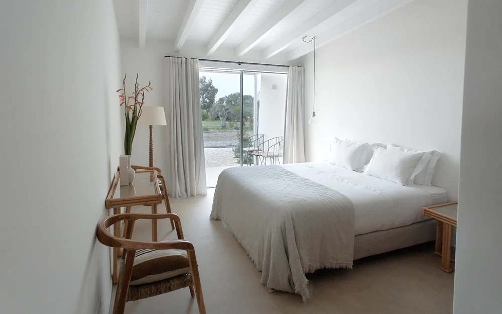 Apartment bedroom with glass doors facing the garden at Amaria