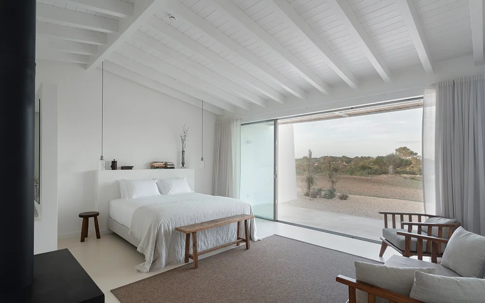 Farmhouse Suite 2 bed beside a broad window overlooking the terrace at Amaria