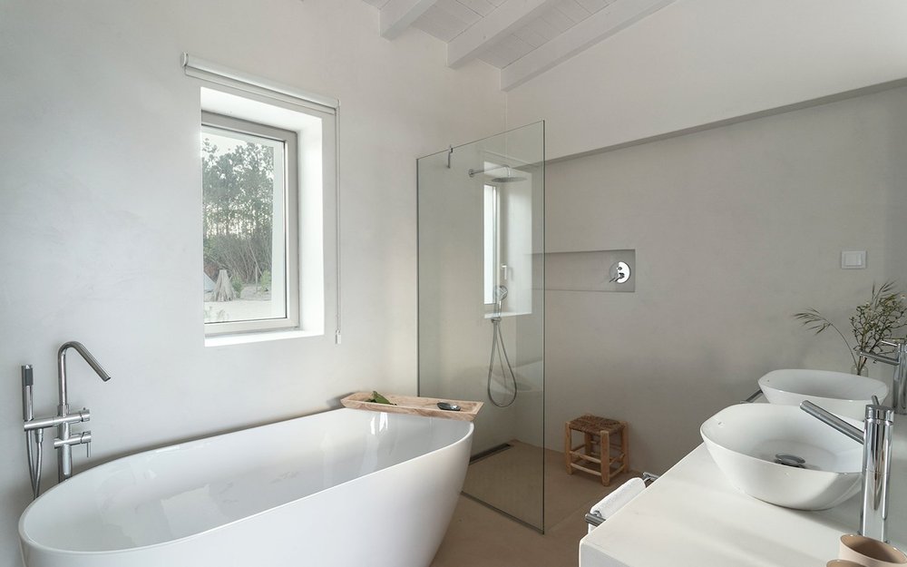 Farmhouse Suite 4 bathroom with bathtub, glass shower and double vanity at Amaria
