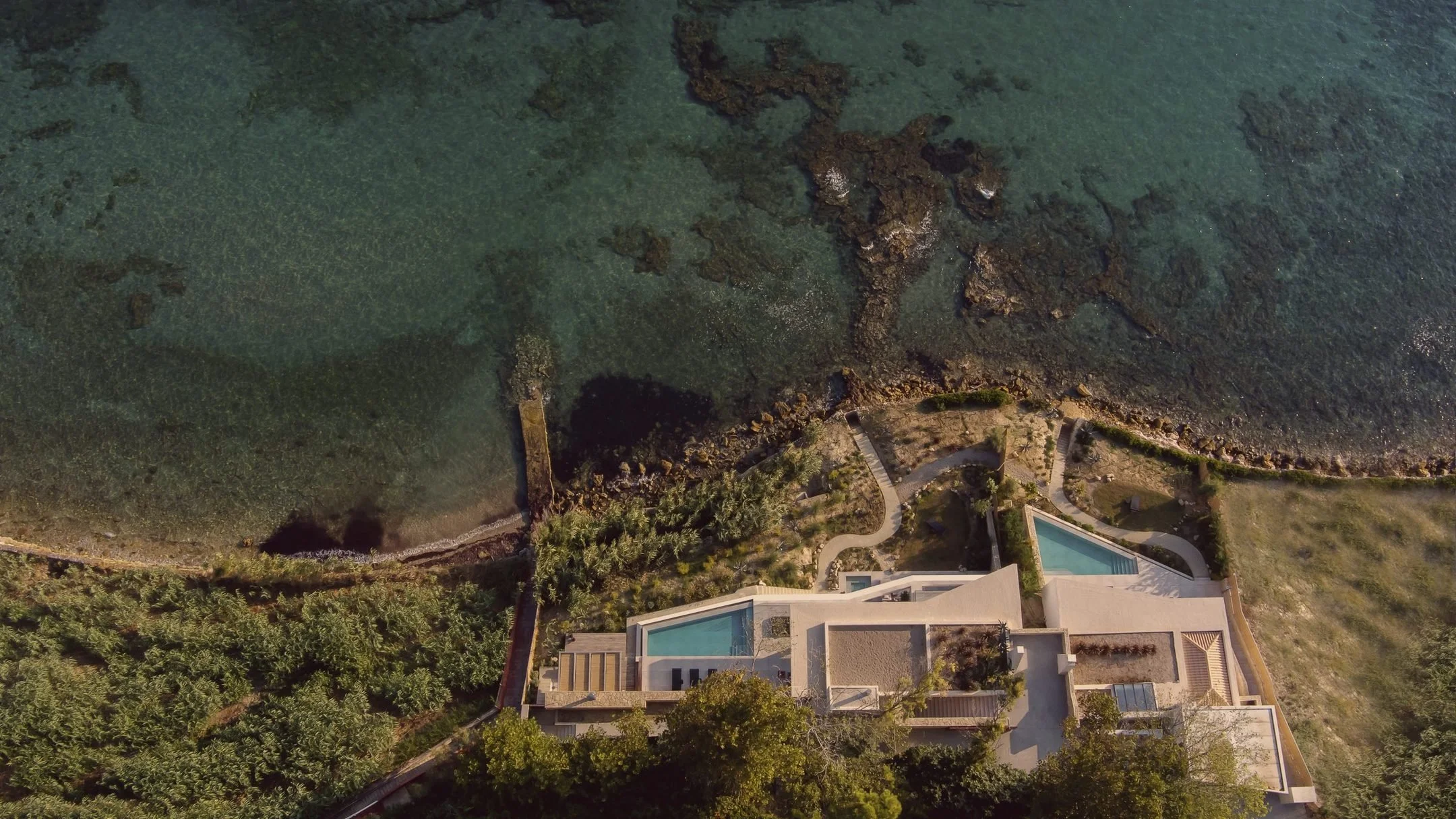 The private estate on Zakynthos, Greece, seen from above among pine trees by the Ionian Sea, home of the Casa Retreats Greece 2027 yoga retreat
