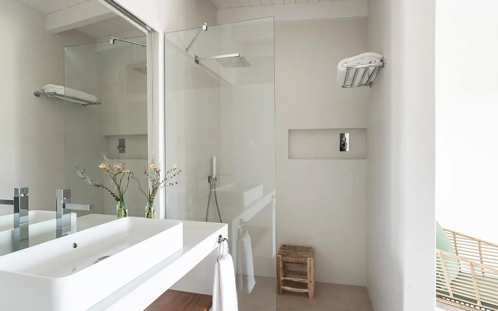 Junior Suite 4 bathroom with double sinks and a glass shower at Amaria