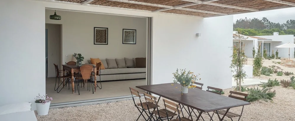 Covered apartment terrace with outdoor seating in daylight at Amaria