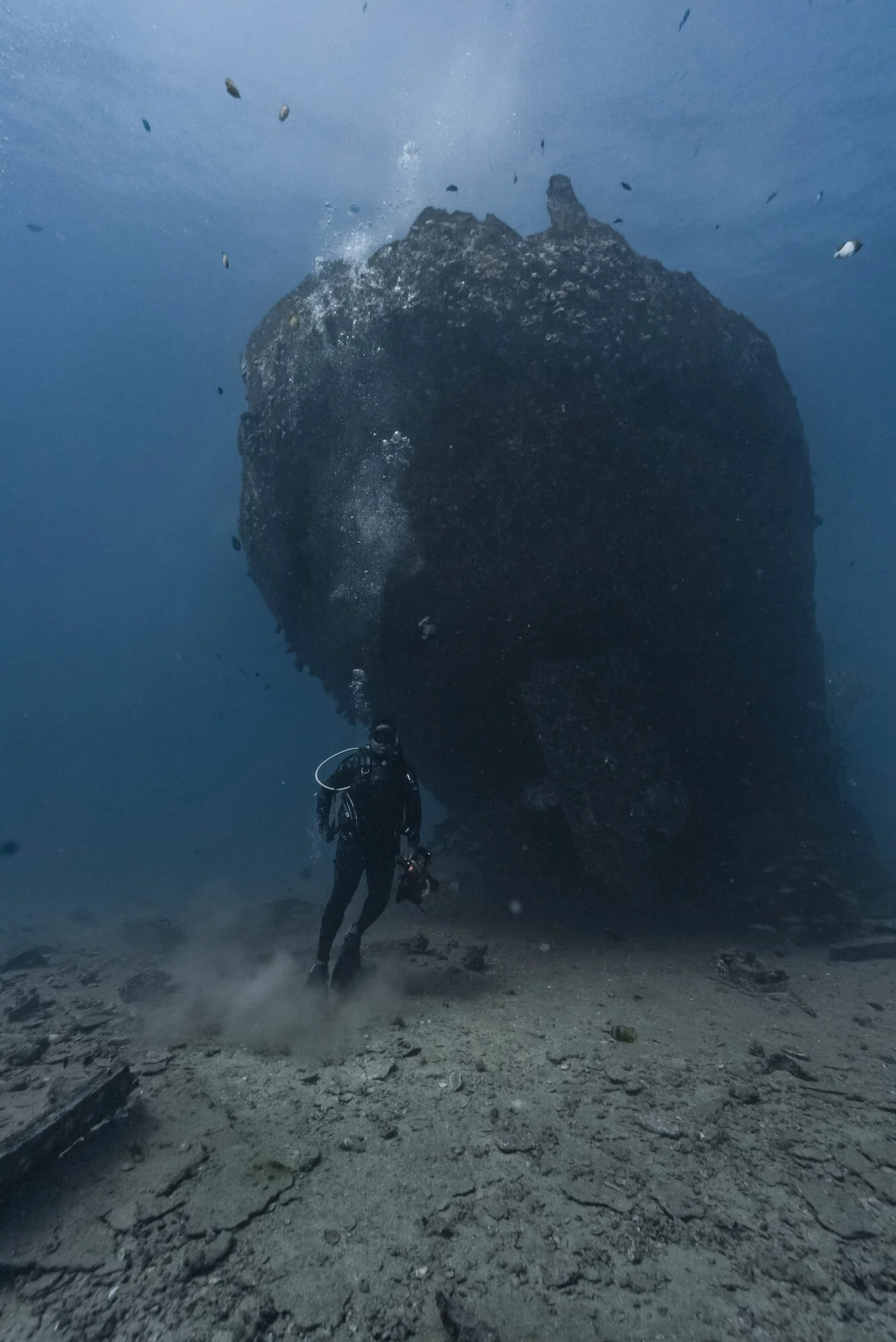 Diver descending toward a sunken structure