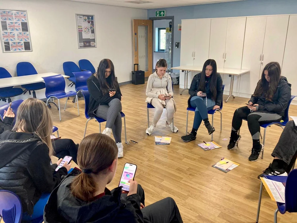 Young women sitting in a circle during a Period Reality session