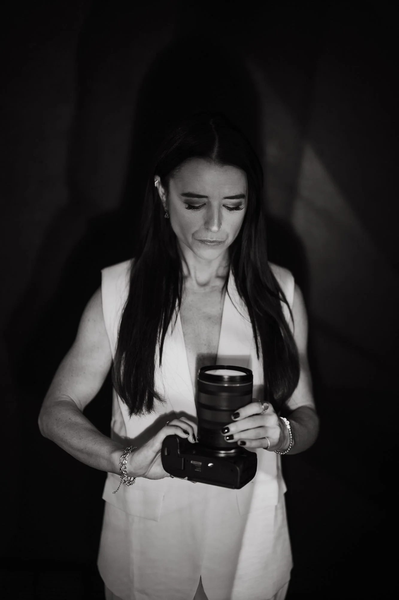 Kaylee holding her camera in black and white