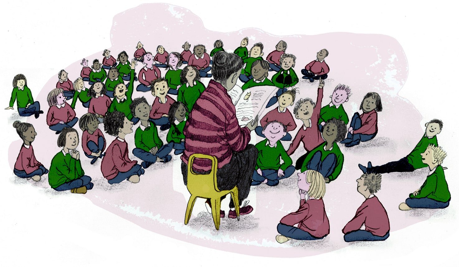 A woman in a purple stripey jumper reads to a class of children sat on the floor with their legs crossed. Two children have their hands up in the air.