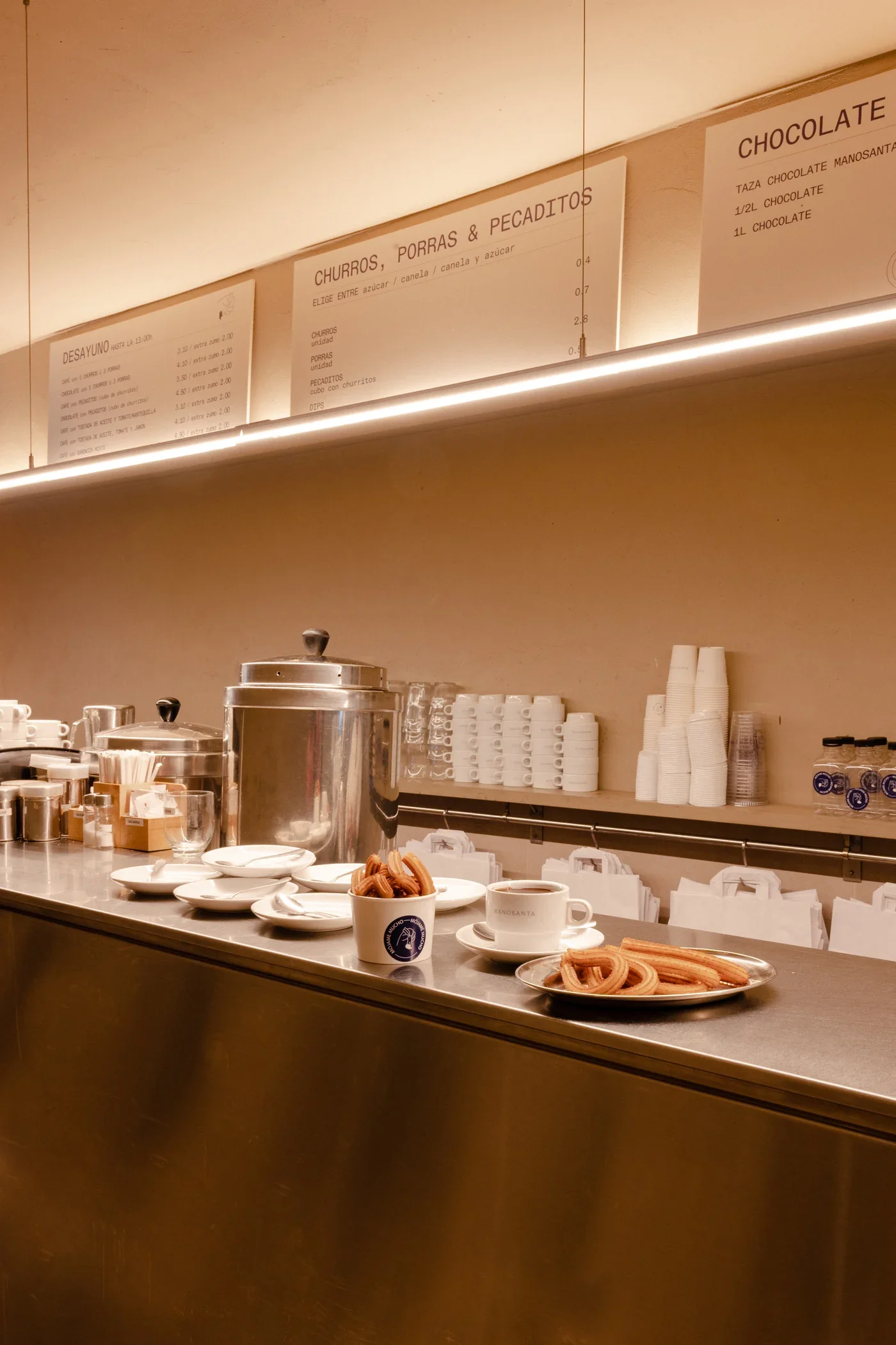 Churros, chocolate y pecaditos servidos en la barra de Manosanta