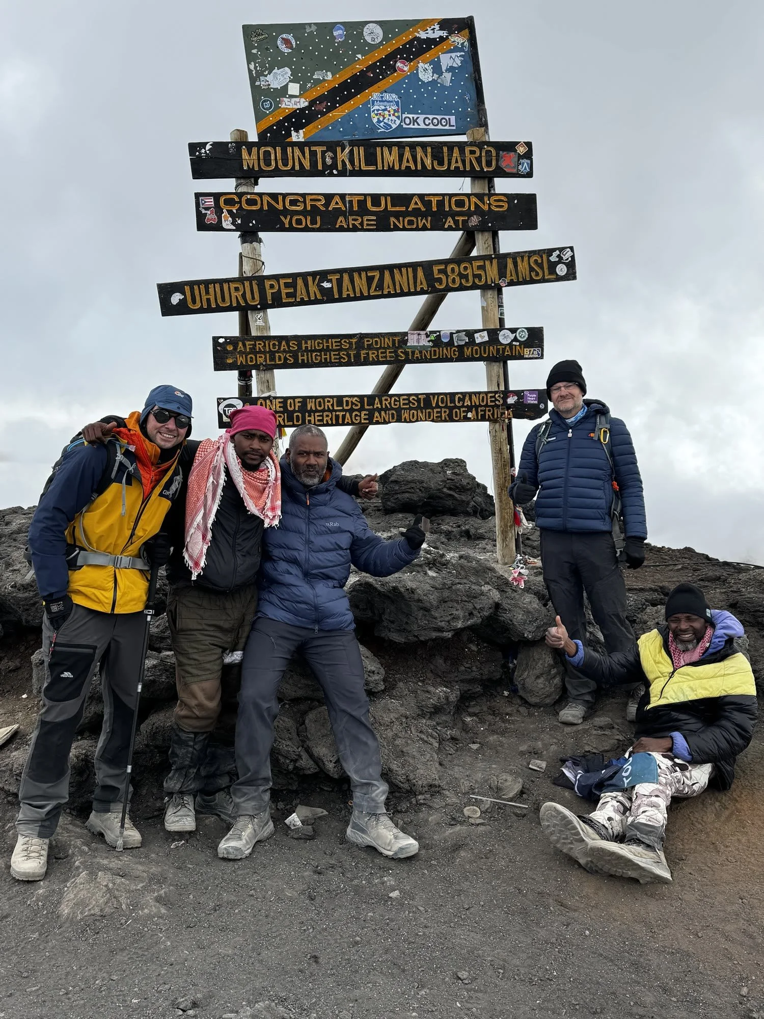 The group celebrating at the Uhuru Peak sign