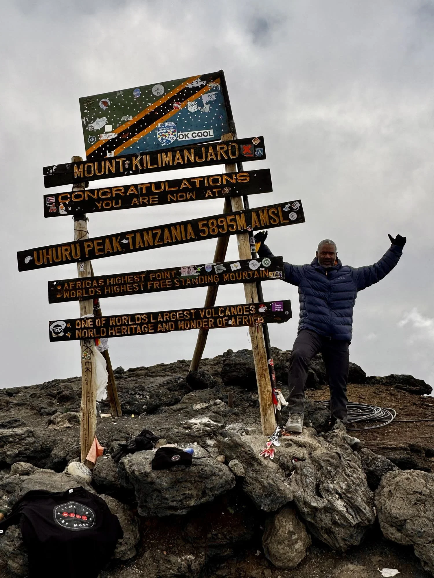 Luciano at Uhuru Peak with the Time To Be More shirt