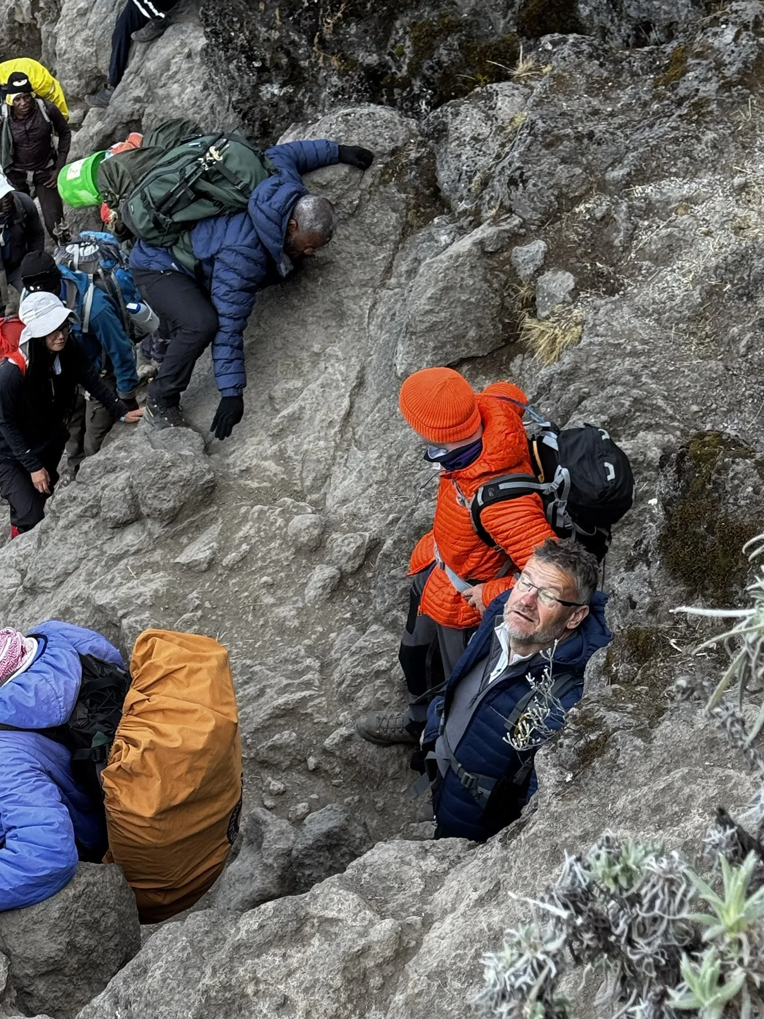 Luciano scrambling up the Barranco Wall in a queue of climbers