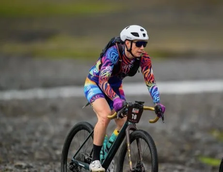 A Campfire rider on a gravel course beside the water