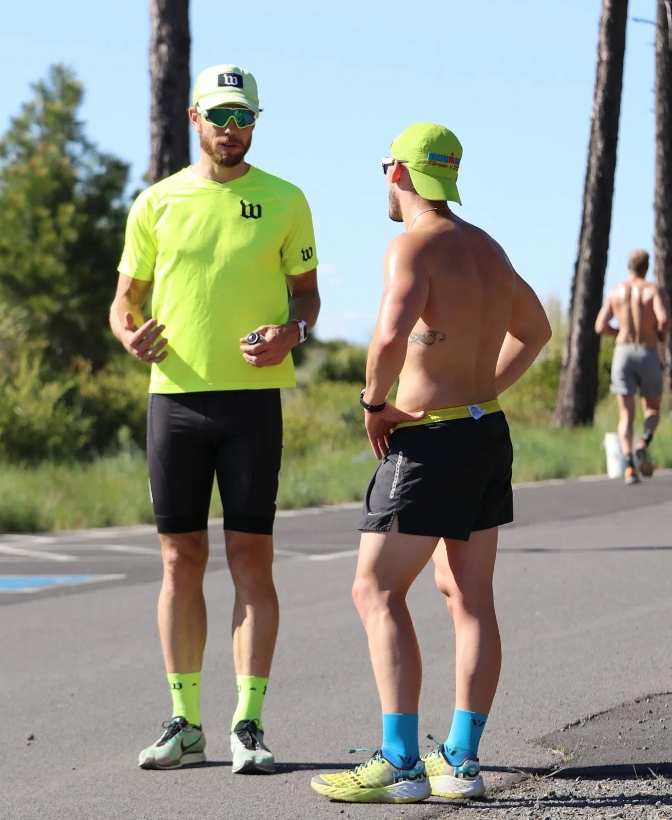 Chris Bagg talking through a session with an athlete at the roadside during a Campfire camp