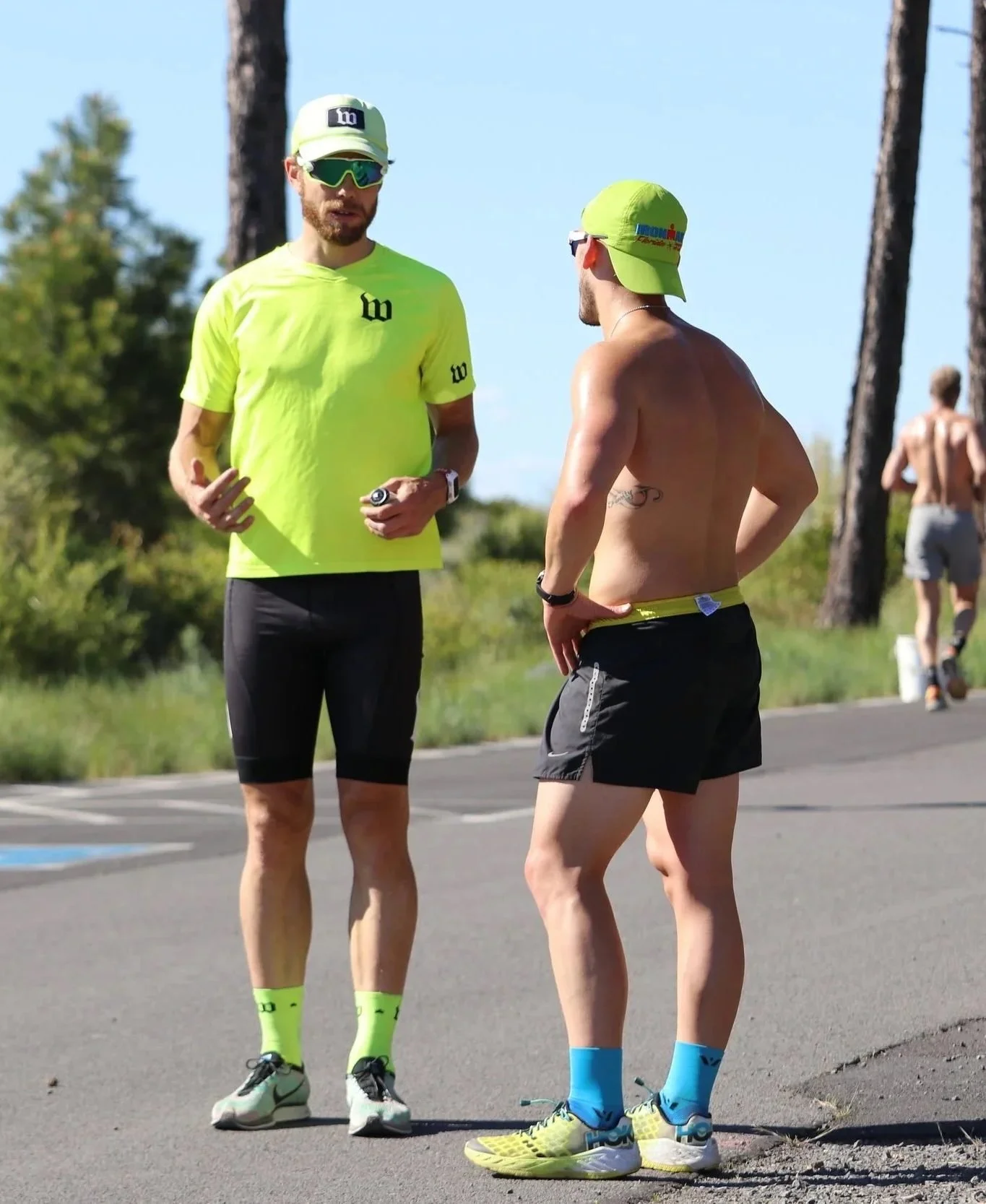 Chris Bagg coaching an athlete roadside during a session