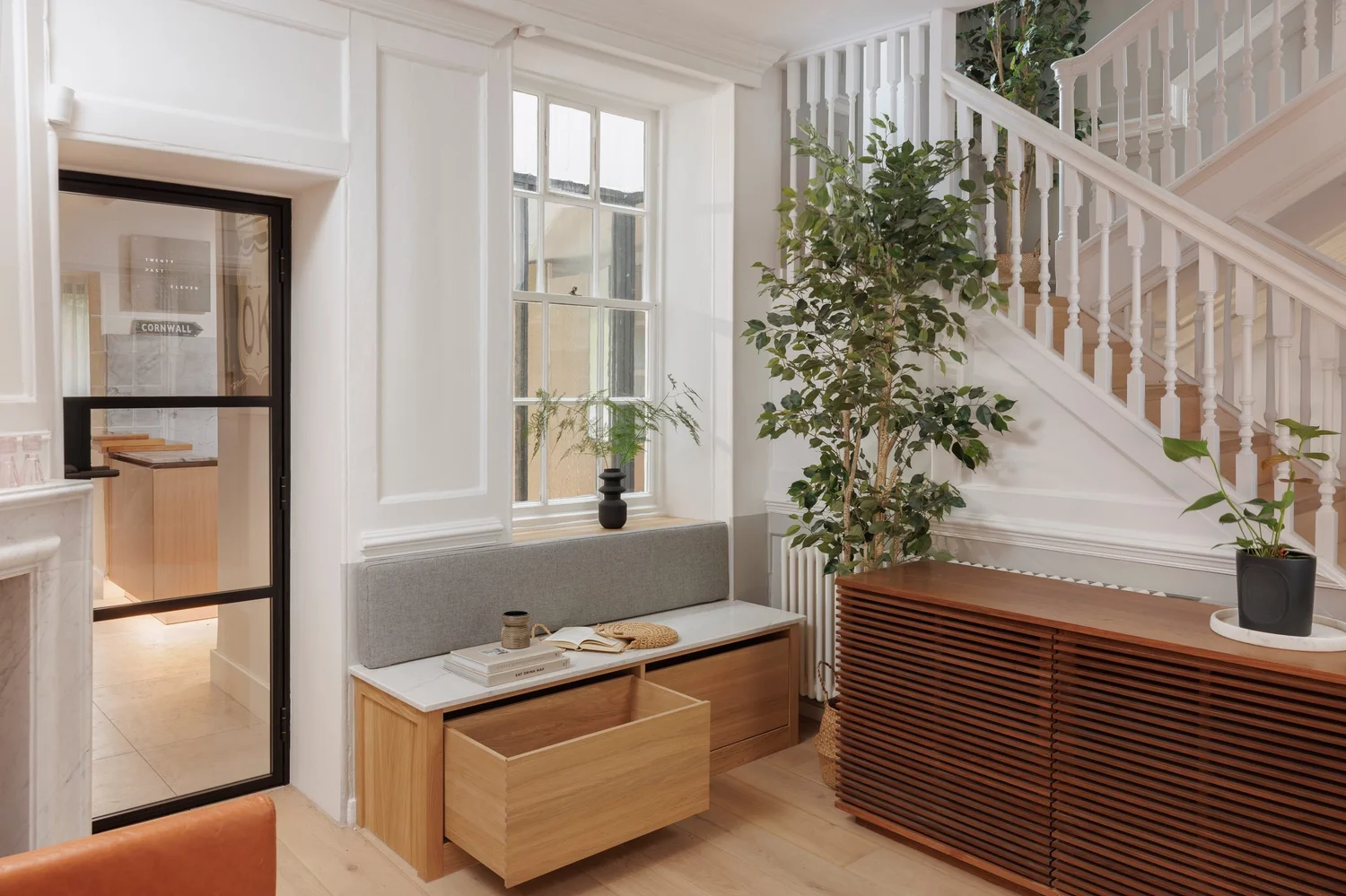 Hallway bench beside a Crittall door, Twickenham, London, by The Coast Creative