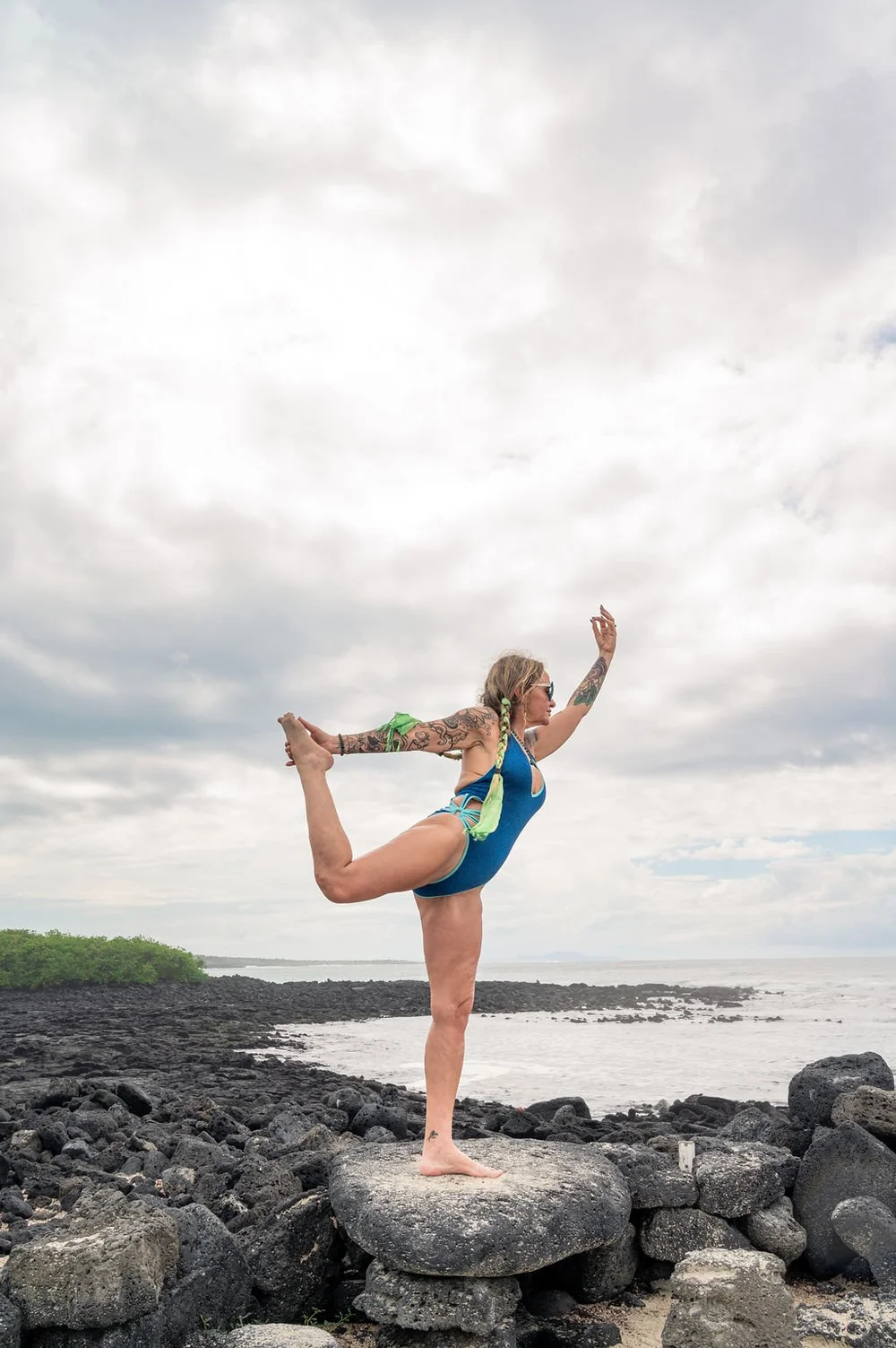 Dancer pose on the deck of a boat during a Galápagos yoga retreat